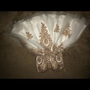A gold and white bejeweled dress.